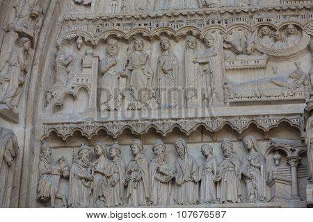 Paris - West facade of Notre Dame Cathedral. The Saint Anne tympanum