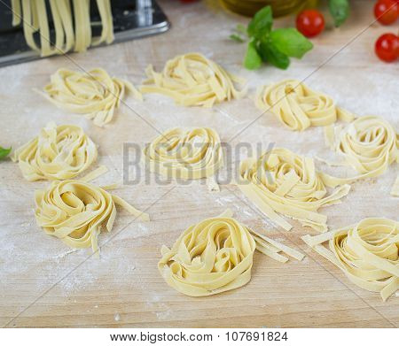 Fresh Homemade Pasta Machine Pasta, Basil, Tomatoes On A Wooden Background