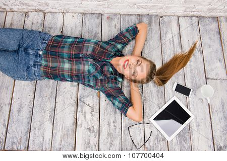 Nice-looking Girl With Tablet, Spectacles, Phone And Cup Lying On The Floar