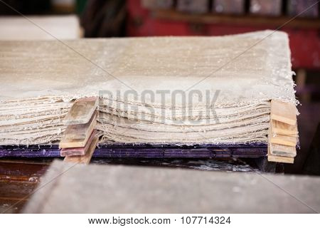 Stack of wet papers drying in factory