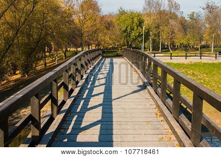 Wooden pedestrian bridge on Bundek lake in Zagreb, Croatia, in autumn