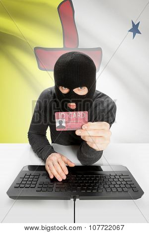 Hacker With Canadian Province Flag On Background Holding Id Card In Hand - Nunavut