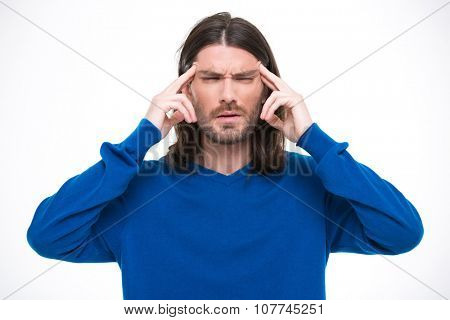 Young handsome man with long hair in blue sweater having headache and touching his temples by fingers