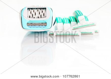 depilator and razor on white - beauty treatment