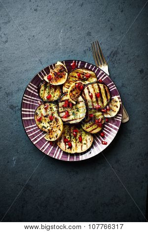 Grilled aubergine marinated in olive oil with ramsons and pomegranate seeds
