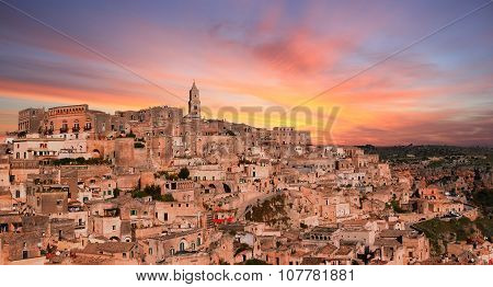 Panoramic View Of Typical Stones And Church Of Matera Under Sunset Sky