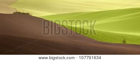 Beautiful countryside panoramic landscape at spring time - agricultural colorful fields