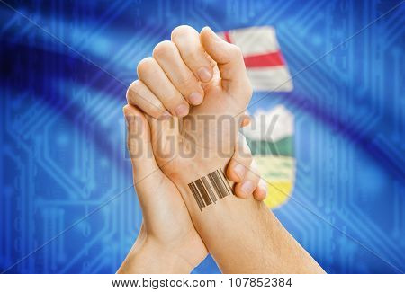 Barcode Id Number On Wrist With Canadian Province Flag On Background - Alberta