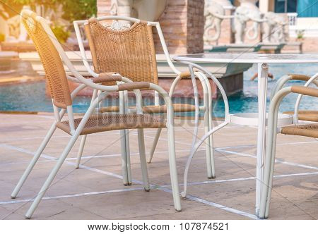 Chairs And Tables Next To Swimming Pool