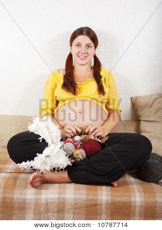 Mulher grávida, tricô com agulha de tricô