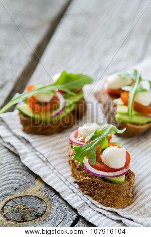 Avocado mozzarella and tomato bruscetta
