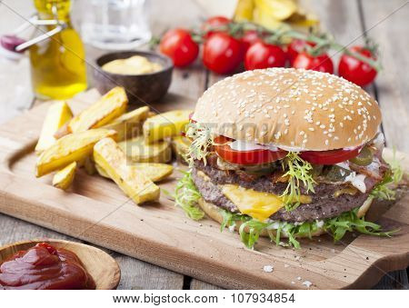 Burger, hamburger with frech fries, ketchup, mustard and fresh vegetables