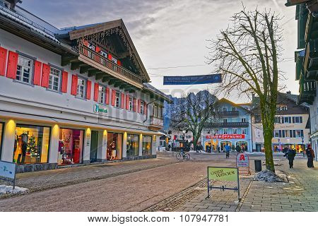 GARMISCH-PARTENKIRCHEN GERMANY - JANUARY 06 2015: Cozy street of Garmisch-Partenkirchen with colorful houses and stores decorated for Christmas holidays