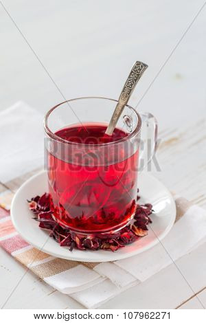 Karkade tea on white wood background