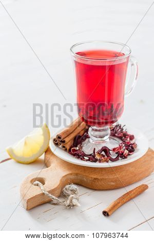 Karkade tea on white wood background