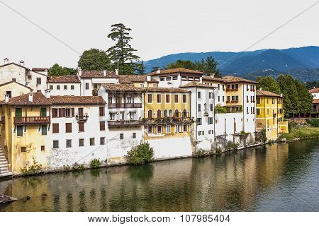 Facade Of Houses At River Brenta With Village Basano Del Grappa