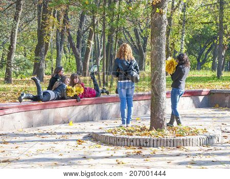 Chernigov,Ukraine, October 19, 2011:Young people photographed  in the autumn park city Chernigov