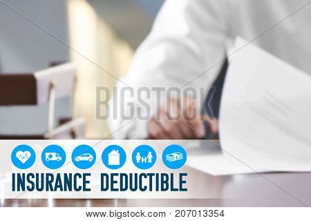 Notary public stamping document at table in office. Concept of insurance deductible