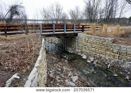 A bridge, along the Little Traverse Wheelway, which connects Charlevoix, Petoskey and Harbor Springs, Michigan, allows hikers and bicyclists to cross Tannery Creek.