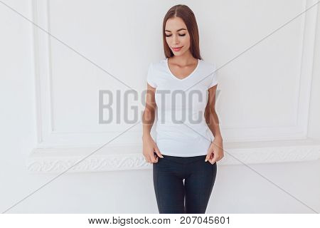 Woman with a big breast in a white T-shirt. Mock-up.