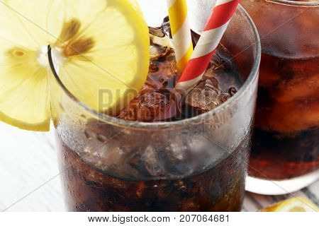 Softdrink With Ice Cubes, Lemon And Straw In Glass