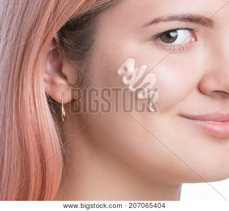 Young pretty girl with foundation on her face