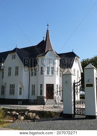 Graasten Denmark - August 24 2009: White Stately home with roof spires in summer sunshine