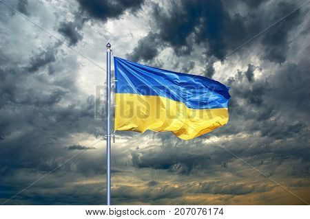 Ukraine flag. Ukrainian flag on black storm cloud sky. stormy weather