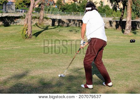 A golfer  he trains   playing in a tournament