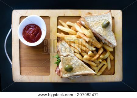 Chicken Club Sandwich On A White Plate With Spicy French Fries.