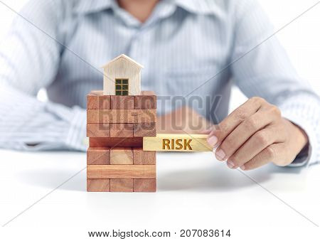 Businessman hold wooden bloc with wording risk, insurance concept