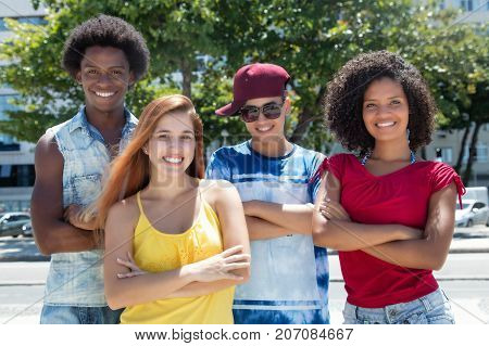 Multi ethnic group of latin and african american and caucasian young adults outdoor in the summer in the city