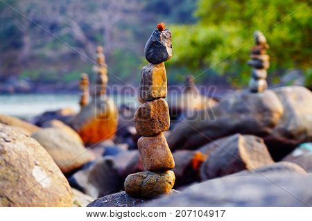 Japanese rock garden on Palolem beach in Goa, India. Zen (dzen) stones. Indian nature. Meditation and relax place on the beach.