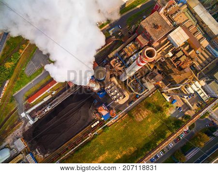 Aerial view of modern combined heat and power plant. Fuming chimney with sulphur removal unit. Heavy industry from above. Power and fuel generation in European Union. 