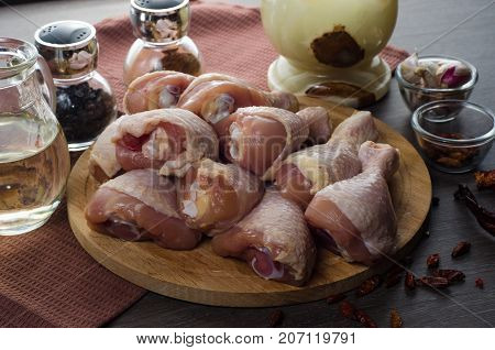 Fresh raw chicken legs arrangement on a kitchen cutting board