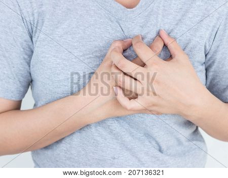 Young woman has chest pain heart attack hands pressing on chest.