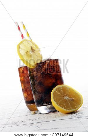 Softdrink With Ice Cubes, Lemon And Straw In Glass
