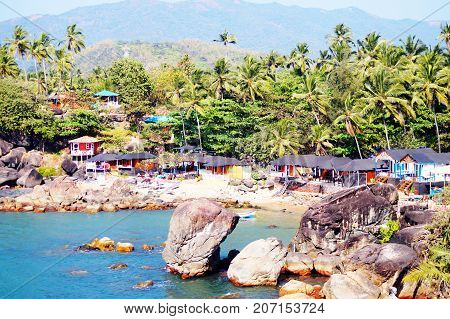 Palolem beach, South Goa, India. One of the best beaches in Goa. Colorful beach huts and palm trees on the coast. Luxury leisure.