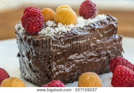 Cake with raspberry on the white plate
