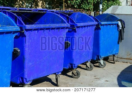 trash cans standing in a row bin Many blue tanks