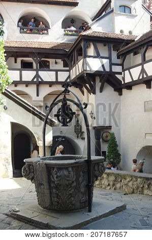 Bran Transylvania Romania - September 14 2017: medieval castle. Thanks to Bram Stoker's book the castle is considered the headquarters of the Dracula vampire. Well in the courtyard.