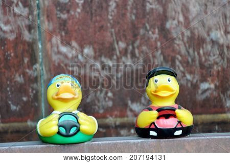 Yellow Plastic Ducks on a fountain with flowing water in the background