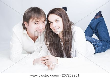 Family Ideas. Cute and Loving Young Caucasian Couple Having Time Together. Communicating on Floor with Each Other and Holding Hands In Touch. Horizontal Image