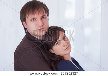 Family Ideas. Young Caucasian Couple Standing Together Embraced. Looking To The Camera. Horizontal Image