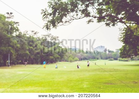 Blurred Background,people Exercise At Green Park In City With Bokeh Light. Healthy Lifestyle Concept