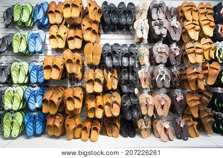 Key West USA-december 26. 2015 : Rubber sandals on shop display shopping . Assortment of male and female shoes of different colors. Pool or beach slides. Summer vacation concept. Recreation