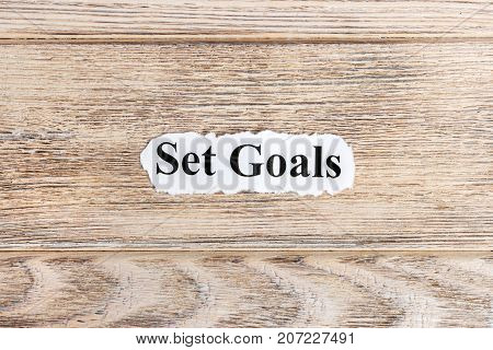 Set goals text on paper. Word Set goals on torn paper. Concept Image.