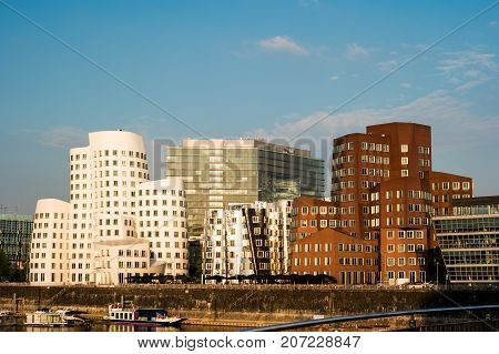 Looking at Media Harbor at Rhine-River in Dusseldorf in Germany. Media Harbor with Rhine-Tower and famous buildings in gentle sunset light. Beautiful and colorful cityscape of the german city