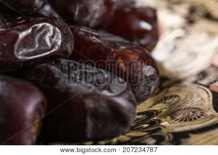 Fresh sweet dates on wooden background, close up
