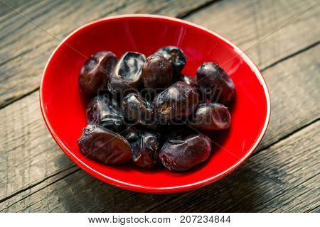 Fresh sweet dates on wooden background, close up